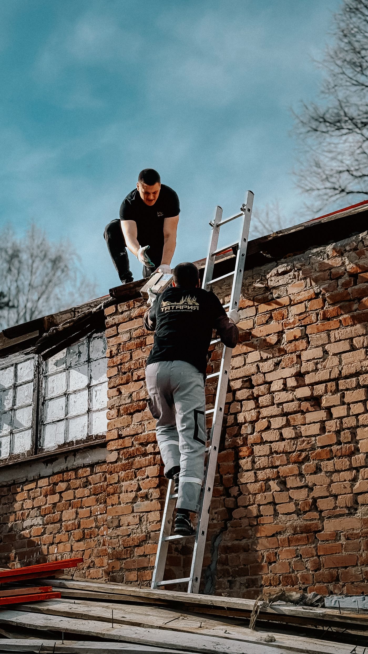 A pitched tile roof being repaired